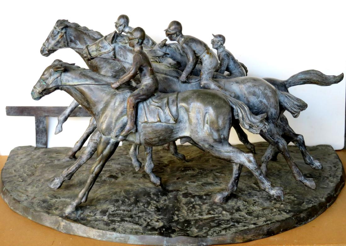 Large hollow bronze sculpture of a horse race depicting