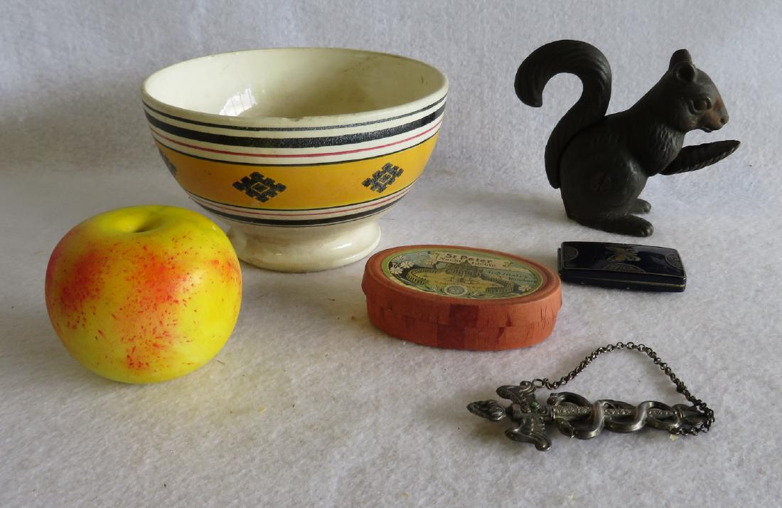 Grouping of decorative objects including a cast iron: Grouping of decorative objects including a cast iron squirrel nut cracker - 4.5"H, medicinal silver needle case - 4"L, enameled lady's compact with interior mirror signed Lucretia Vanderbilt NY, and a
