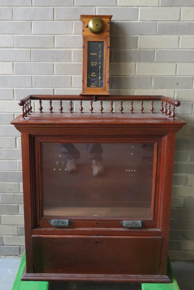 Victorian black walnut butler/maid calling unit,: Victorian black walnut butler/maid calling unit, missing mechanicals. The glass front door has 2 cast iron handles that assist in lifting the door through the mortised top to expose the interior. This