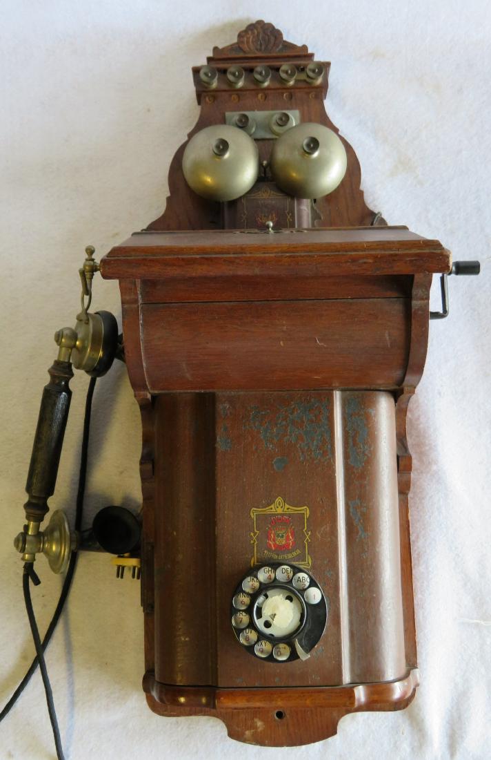 Danish oak wall phone with sticker marked JYDSK Telefon: Danish oak wall phone with sticker marked JYDSK Telefon Aktieselskab – 28.25”L – original finish and in very good condition. Early 20th century.