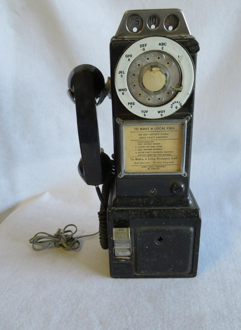 Northern Electric painted cast iron wall mounted pay: Northern Electric painted cast iron wall mounted pay phone with slots for nickels, dimes, and quarters - original black paint with enameled white dial. Circa 1960-70. Very good condition. 18"H.