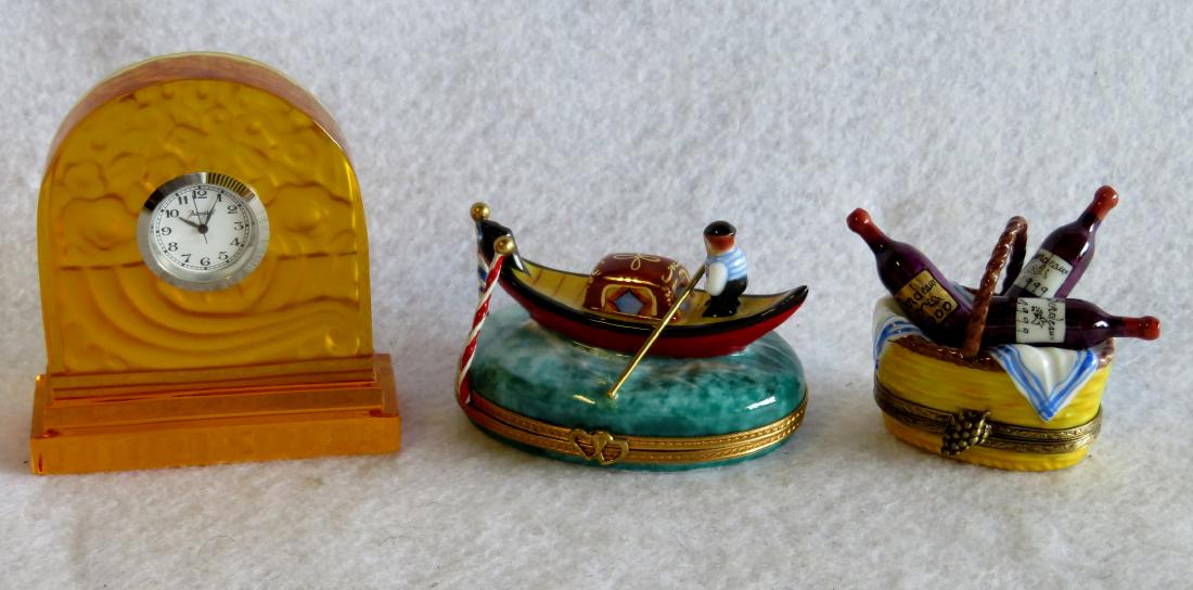 Grouping of 3 miniature decorative objects including an: Grouping of 3 miniature decorative objects including an amber Baccarat clock (non-working), and 2 Limoges Imports fancy covered porcelain boxes. All in excellent condition.