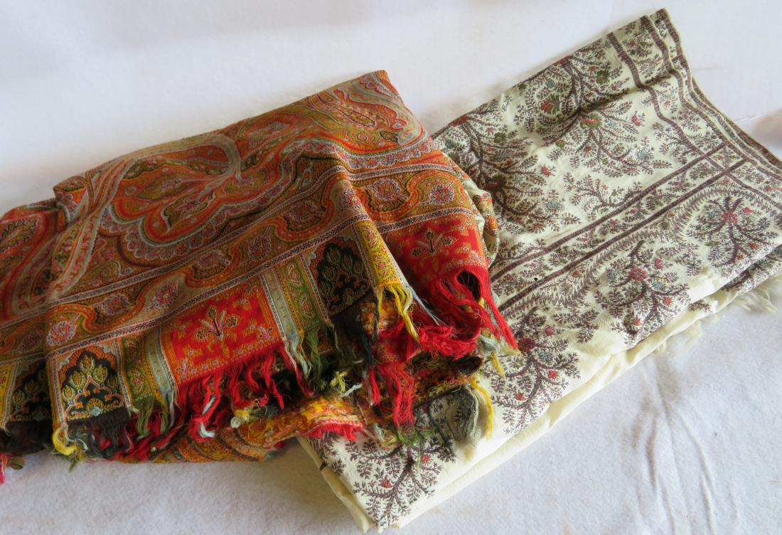 Two paisley shawls with white/cream central medallions: Two paisley shawls with white/cream central medallions - 19th century - some moth holes and minor repair on white areas, else good condition. The larger paisley appears to have the pattern sewn into t