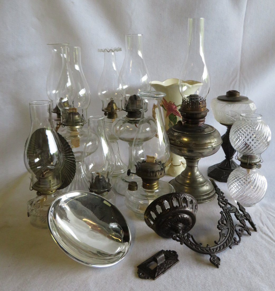 Groupiing of mostly Victorian era oil lamps.: Grouping of 10 oil lamps and a signed Hull vase. Lamps include a nickle plated Rayo, one with an Eastlake cast iron base (no burner), a wall lamp with a cast iron holder and a mercury glass reflector 