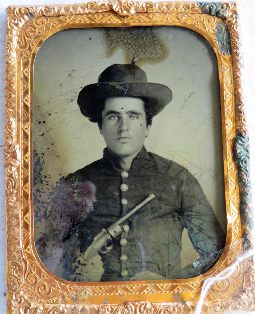 Ambrotype of Civil War soldier holding what appears to: Ambrotype of Civil War soldier holding what appears to be a pepper box pistol - quarter plate with gold mat, no case - some emulsion loss on bottom left and crazing near top center, else good conditio