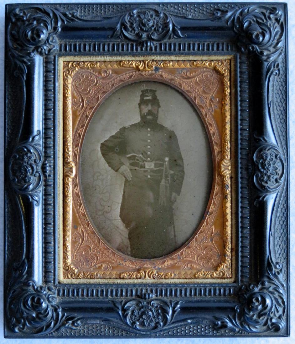 Ambrotype of Civil War officer standing with hand on: Ambrotype of Civil War officer standing with hand on hip and wearing sword and revolver in belt - quarter plate mounted in a gutta percha wall frame in excellent condition, the image with very slight