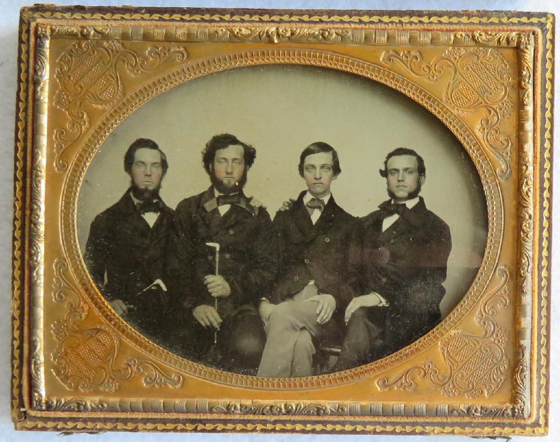 Half plate ambrotype of 4 men, 2 holding canes, mounted: Half plate ambrotype of 4 men, 2 holding canes, mounted in leather-like case. The image in very good condition. The case with wear and detached hinge.