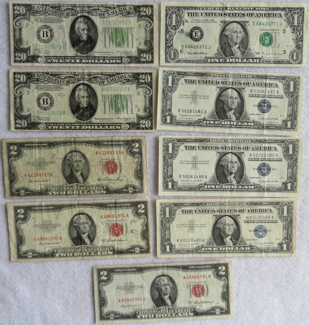 Grouping of currency including 2 twenty dollar bills: Grouping of currency including 2 twenty dollar bills from 1934, 3 two dollar bills from 1953, 3 one dollar silver certificates form 1957, and 1 error one dollar note with ink smudge from 1995. All in