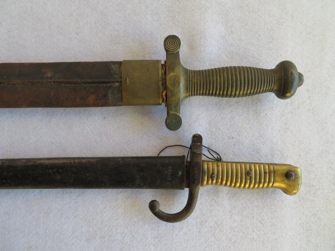 Two military weapons including a French artillery short: Two military weapons including a French artillery short sword dated Jan. 1832 (model 1831 used until 1870), with original scabbard - 25.25" overall length -the tip of the blade with very slight ding t