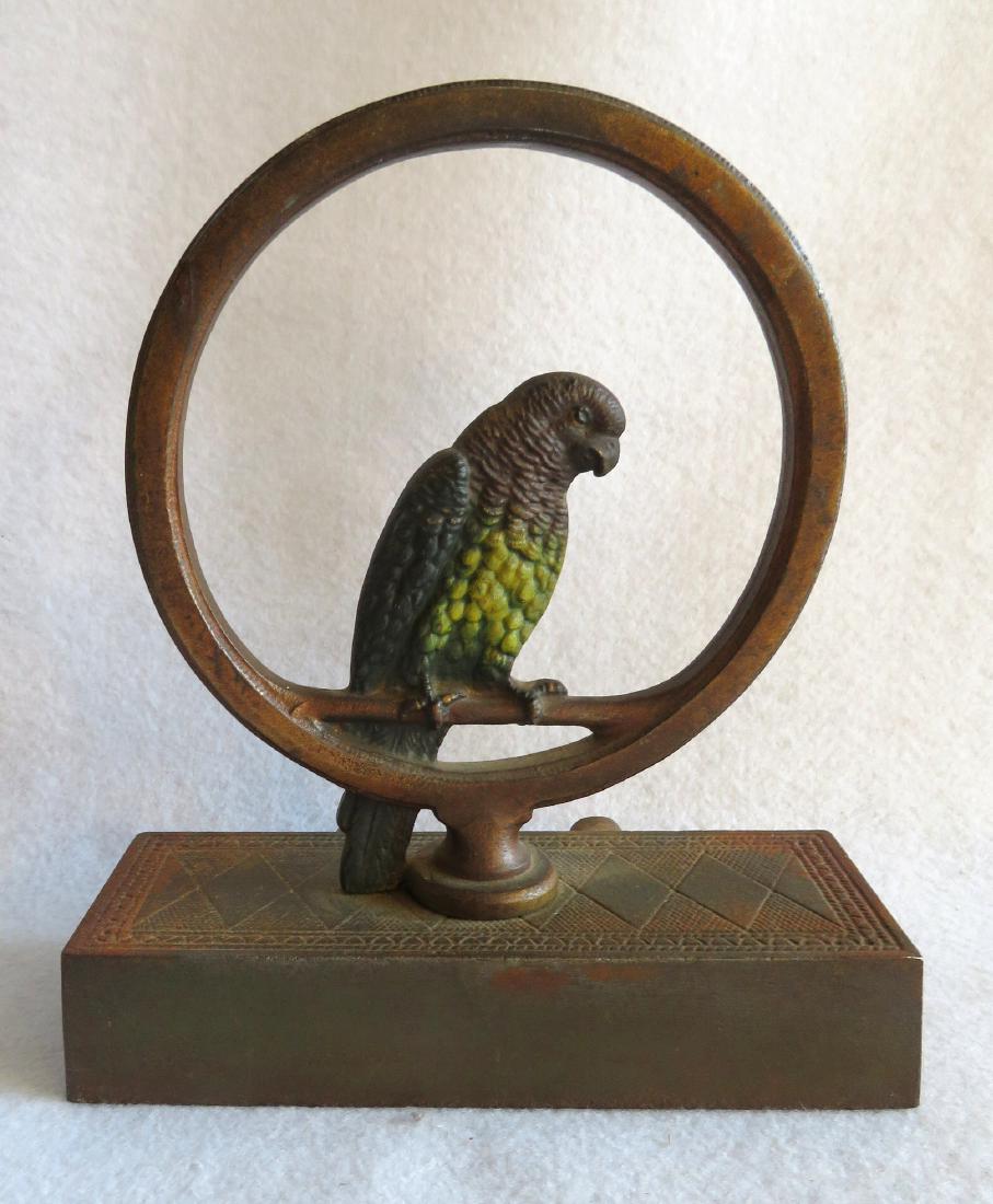 Cast iron door stop - parrot in ring - 2 piece: Cast iron door stop - parrot in ring - 2 piece casting, not signed by known to be made by Bradley & Hubbard. Original paint and still retains its original bumpers on reverse. Excellent condition. 8"H 