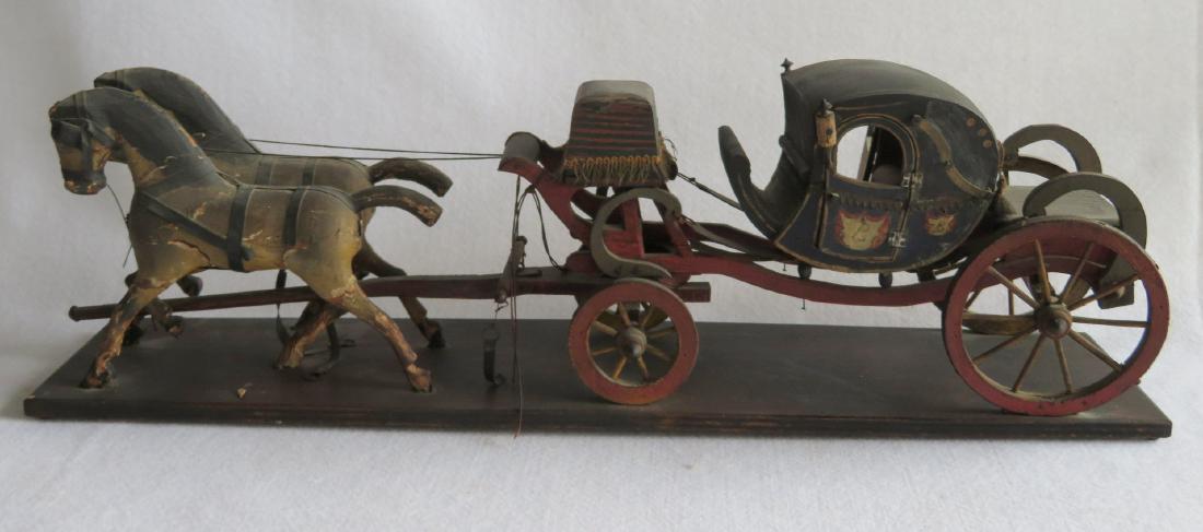 Folk art hand made wooden English coach pulled by 2: Folk art hand made wooden English coach pulled by 2 horses in original paint, late 19th to early 20th century. Slight wear with some tiny paint chips, one loose reign (string), but overall very good c