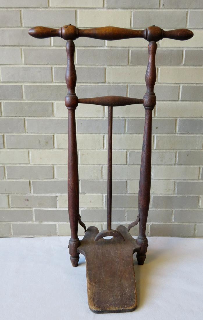 Unusual floor standing boot jack and towel rack, with: Unusual floor standing boot jack and towel rack, with mechanism to assist the user in removing his boots - when not in use, it is used for a towel rack. Original paper label on base marked "Combinatio