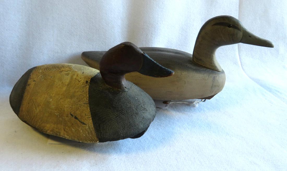 Two primitive decoys including a canvas back and a: Two primitive decoys including a canvas back and a black duck hen signed Decoys Unlimited R.D. #5 Wattsburg Rd - Erie Penna. - Both in very good condition in original paint. Note - mark on the latter