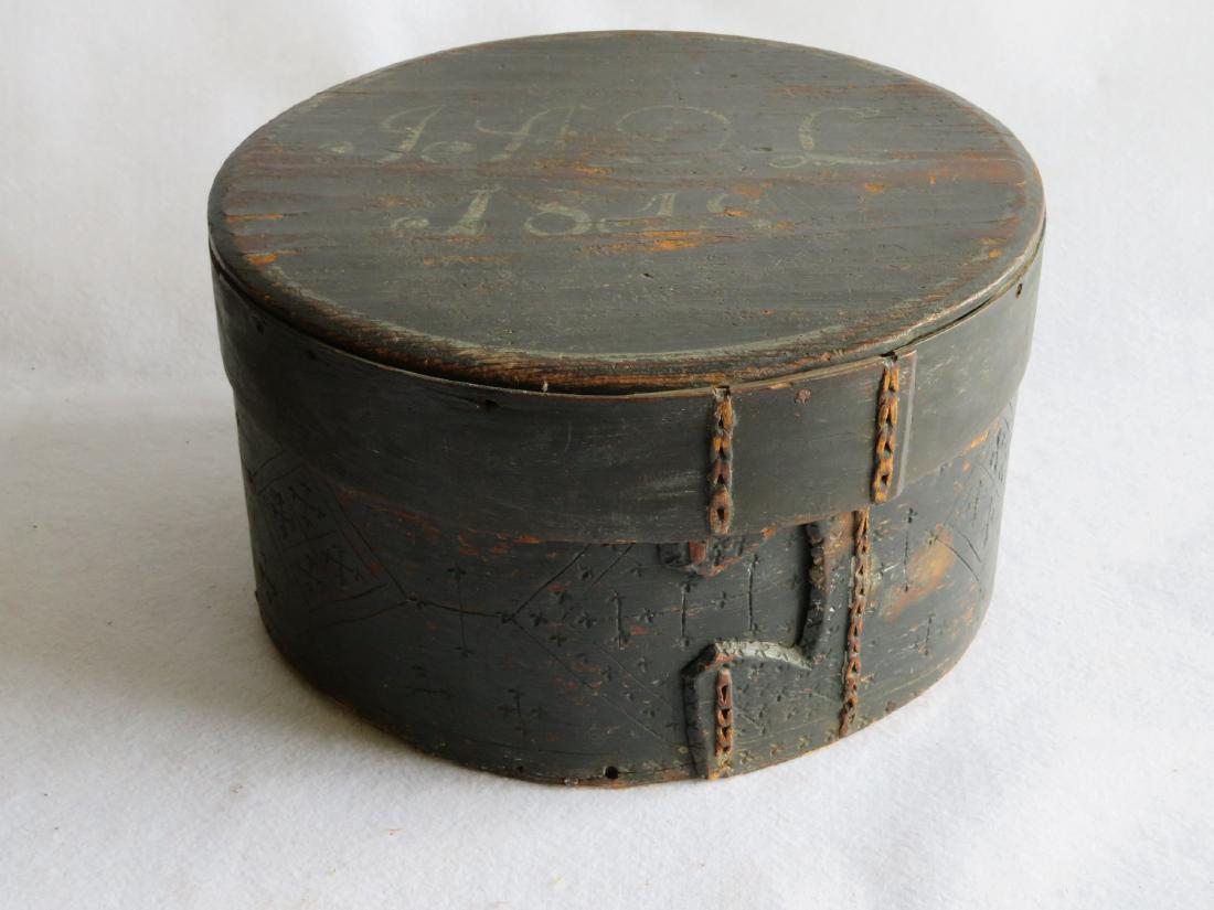 Large lidded and paint decorated pantry box in original: Large lidded and paint decorated pantry box in original dark blue paint with white free hand signature and date on lid "JADL / 1818". Sewn leather lap joints with incised decorations around body. 13.5