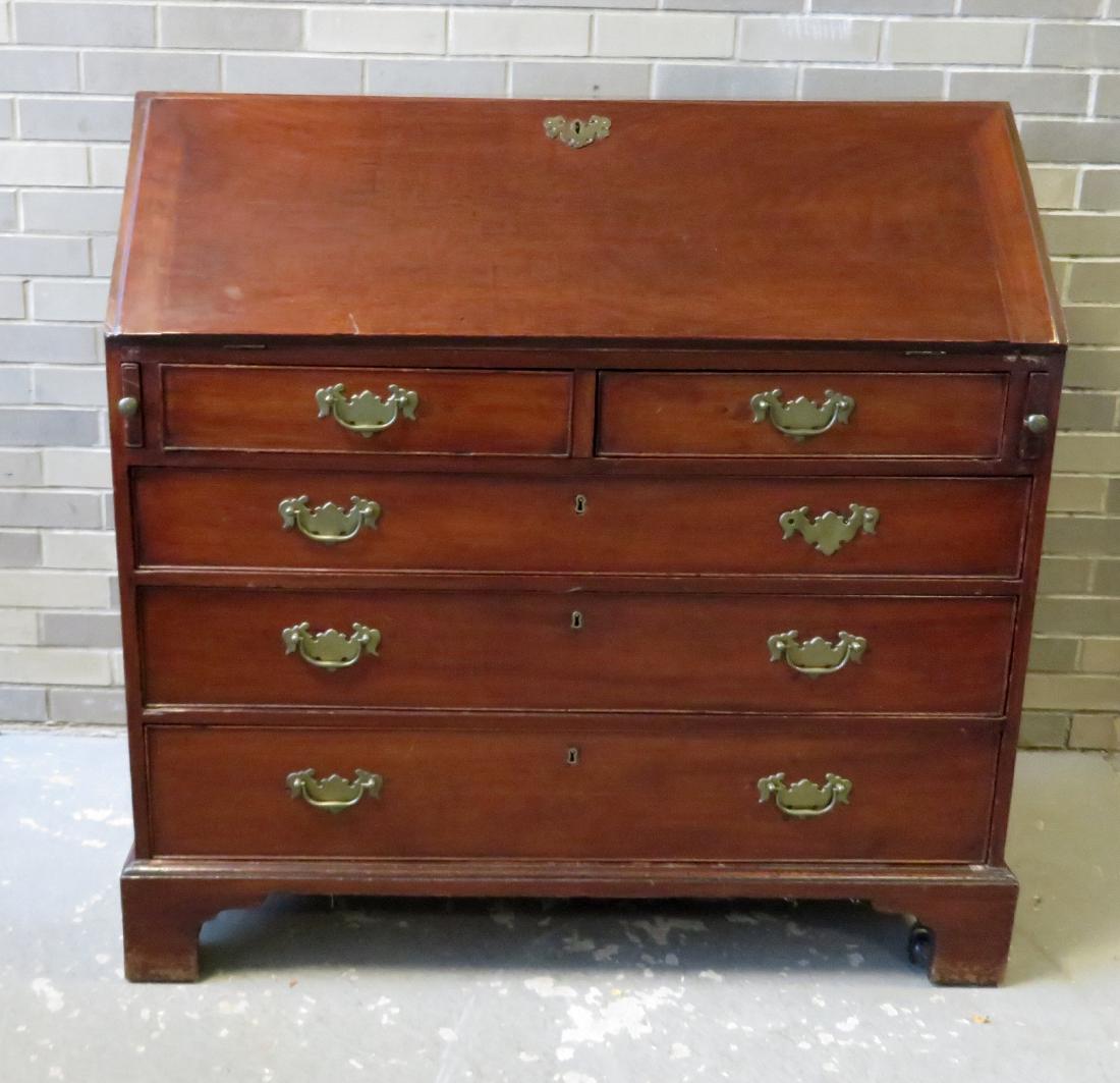 Chippendale slant front desk in a cherry color, having: Chippendale slant front desk in a cherry color, having 10 interior drawers and cubby holes - the desk with 2 shorts drawers over 3 graduated drawers on bracket base. Replaced pulls - some scratches on