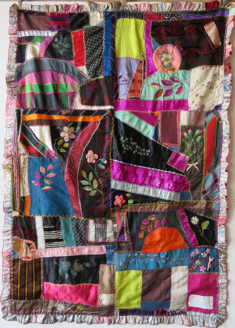 Crazy crib quilt with embroidered front and back. The: Crazy crib quilt with embroidered front and back. The back side is plain with large hand sewn patches. The front side with ornate decoration including hand painted flowers, embroidered raised flowers,