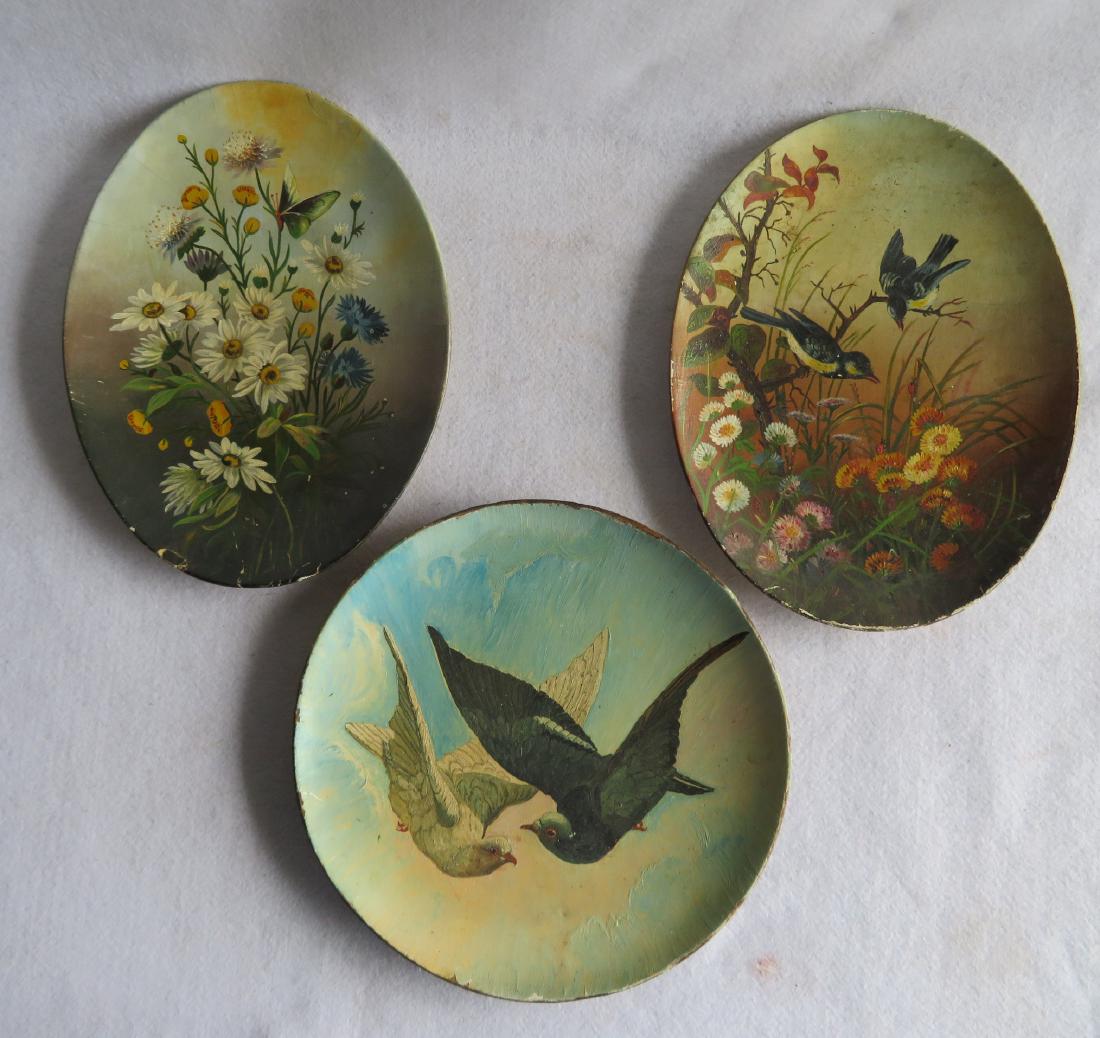 Three 19th century paper mache hand painted plates: 1): Three 19th century paper mache hand painted plates: 1) Oval plate with birds in flower garden feeding on beetles - 10" x 13" - slight paint chips on rim, otherwise very good condition; 2) Oval plate, 