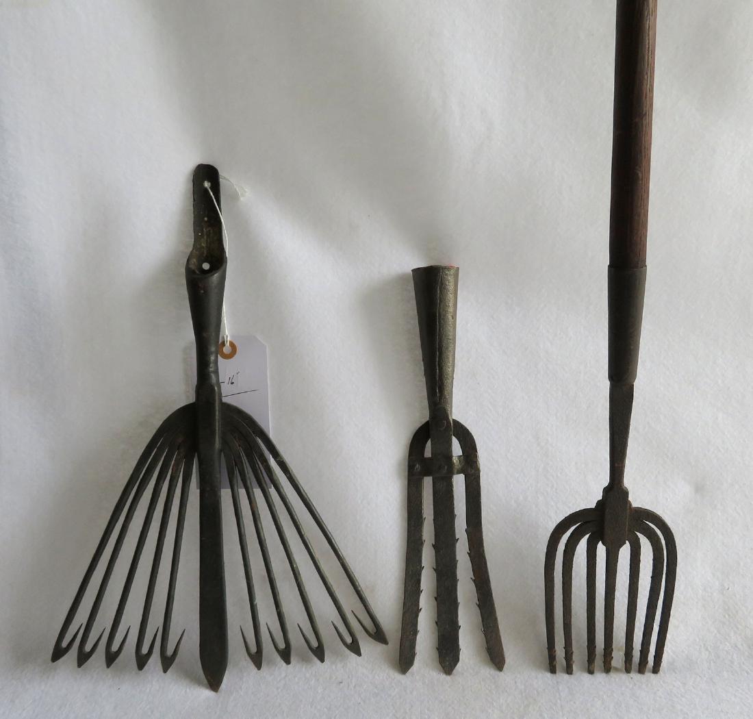 Three early iron eel spears one appears to retain: Three early iron eel spears, one appears to retain original wooden pole and stamped on iron "Ideal" - all cast and hand forged iron - 19th century and in very good condition. The largest being 10"W x
