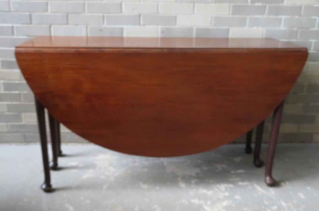 Queen Anne swing leg drop leaf table in black walnut,: Large Queen Anne swing leg drop leaf dining table in black walnut, oval form with pad feet - secondary wood appears to be white pine - the underside still with traces of old red stain. Note that the t