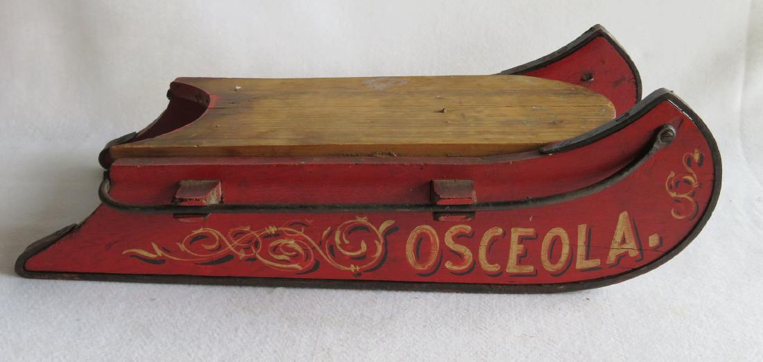 Small child's sled in original red paint with scrolling: Small child's sled in original red paint with scrolling and stenciling marked "OSCEOLA." Due its small size, and bulky weight, possibly a salesman sample. 21.5"L x 10.5"W. Very good condition, 19th ce