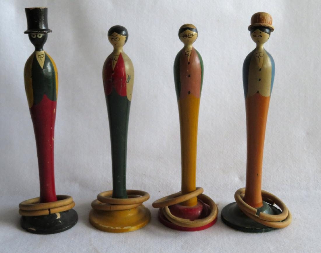Old ring toss game in original paint - the pins hand: Old ring toss game in original paint - the pins hand carved in form of a butler, maid, man and woman - 2 without hats - 9 rings, some with breaks. Early 20th century. The tallest is 14"H.
