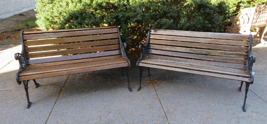 Two contemporary garden benches.: Two contemporary garden benches with ornate cast iron frames & arms and wooden slats in seat and curved back - late 20th century. Very good condition.50"L x 24"D x 28"H.