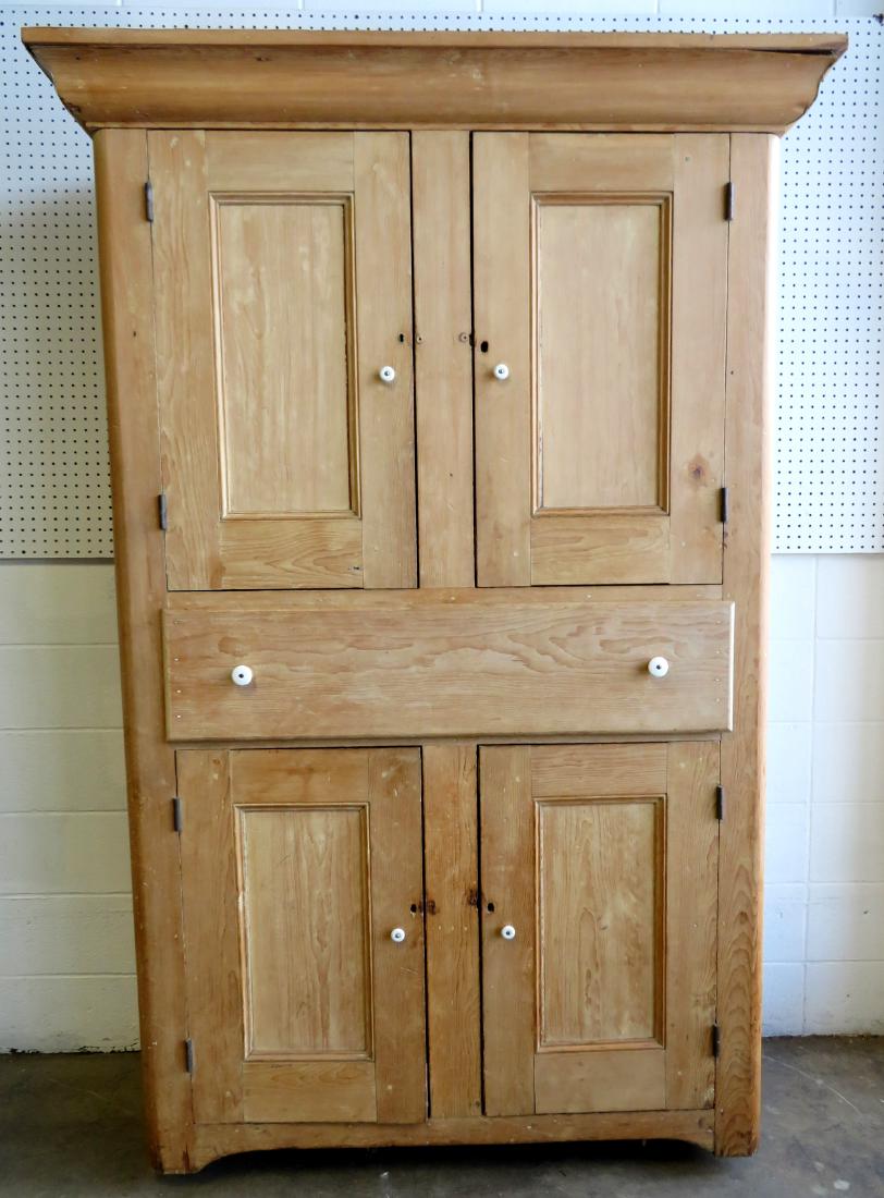 Large pine kitchen cupboard with white porcelain knobs,: Large pine kitchen cupboard with white porcelain knobs, having 2 paneled doors over 1 large deep drawer over 2 paneled doors, scraped down to original natural pine finish - large cornice and a cutout 