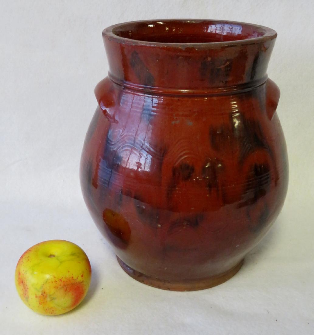 Redware ovoid storage jar with handles, high collar,: Redware ovoid storage jar with handles, high collar, and manganese decorations, also having 4 bands of incised lines around perimeter, 2 bands in a wavy pattern - 11"H x 10"D. Two glazing chips on col