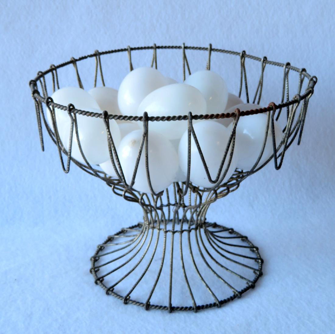 Wire egg basket holding 15 hand blown glass eggs, all: Wire egg basket holding 15 hand blown glass eggs, all 19th century including the basket. Excellent condition. No damage. Provenance: From the locally historic Abraham E. VanWagner homestead, being in 