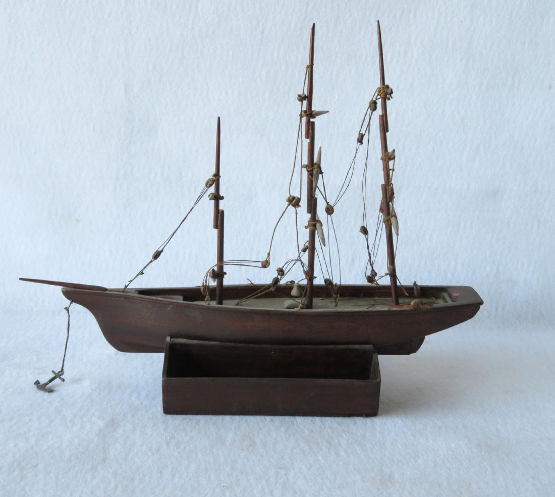 Hand made wooden 3 mast mahogany sailing vessel, rigged: Hand made wooden 3 mast mahogany sailing vessel, rigged with deadeyes and rope, but never had sails - small brass bell and a lead anchor attached - hull appears to be carved from a single piece of woo