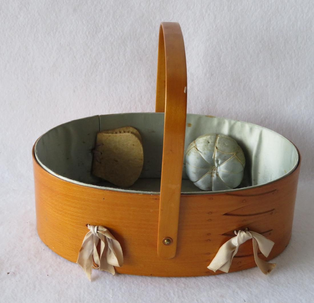 Shaker sewing box with swivel handle, original silk: Shaker sewing box with swivel handle, original silk interior with pin cushion and felt needle holder - also retaining original ribbons that hold the interior to the wooden frame. Stamped on base Sabba