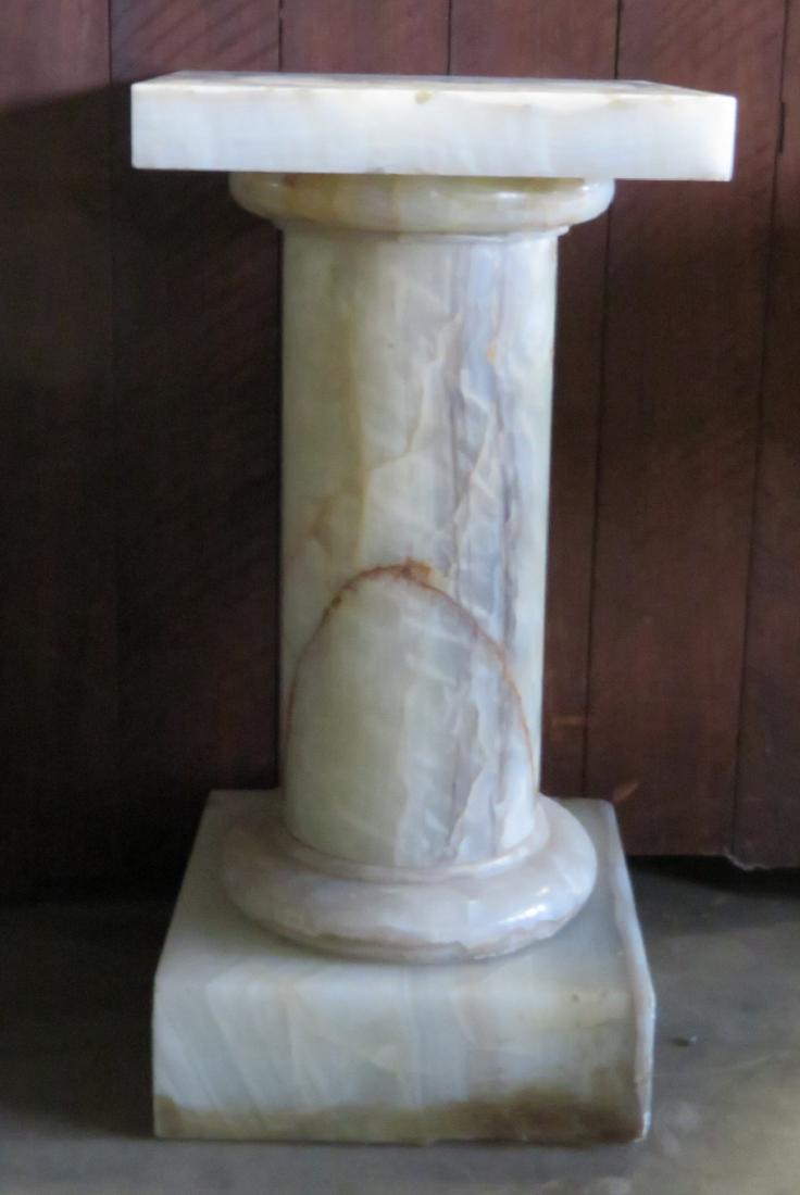 Alabaster pedestal having a thick square top over a: Alabaster pedestal having a thick square top over a round pedestal on a large square base - 15" x 15" top x 29.5"H. Some minor chips on edge of top and base, overall good condition. Late 19th to early
