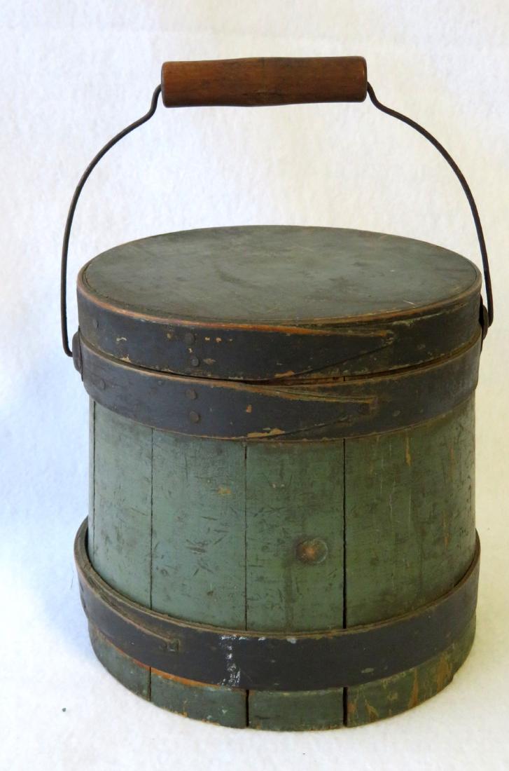 Small size wooden firkin in original green and black: Small size wooden firkin in original green and black paint with bail handle - one small nail that holds the bail support is missing, the top of lid has an old glue repair to fasten a break at the top