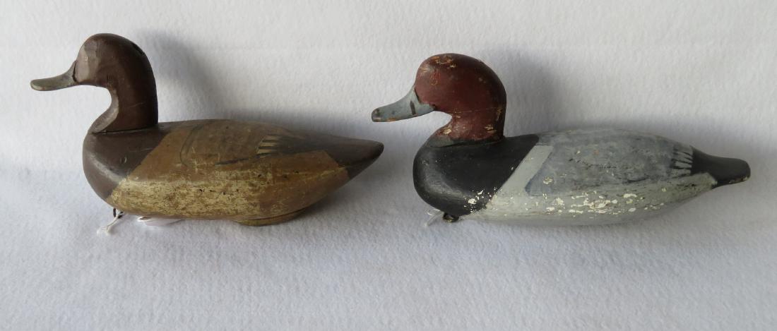 Two Havre-De-Grace style decoys. The drake branded JH,: Two Havre-De-Grace style decoys. The drake branded JH, probably from the rig of John Hanson - good used condition; the hen with repair to body. Both with minor touchup. Early 20th century.