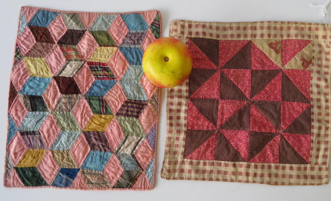 Two hand sewn doll's quilts including tumbling block: Two hand sewn doll's quilts including tumbling block and pinwheel design with border. 11" x 11" and 12" x 10.