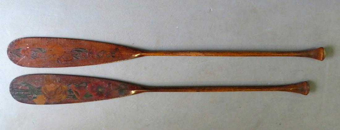 Two carved wooden Flemish art canoe paddles, probably: Two carved wooden Flemish art canoe paddles, probably for a man and woman: 1) Woman's paddle decorated with an Art Nouveau style woman surrounded by flowers on one side, the other side marked ALICE in