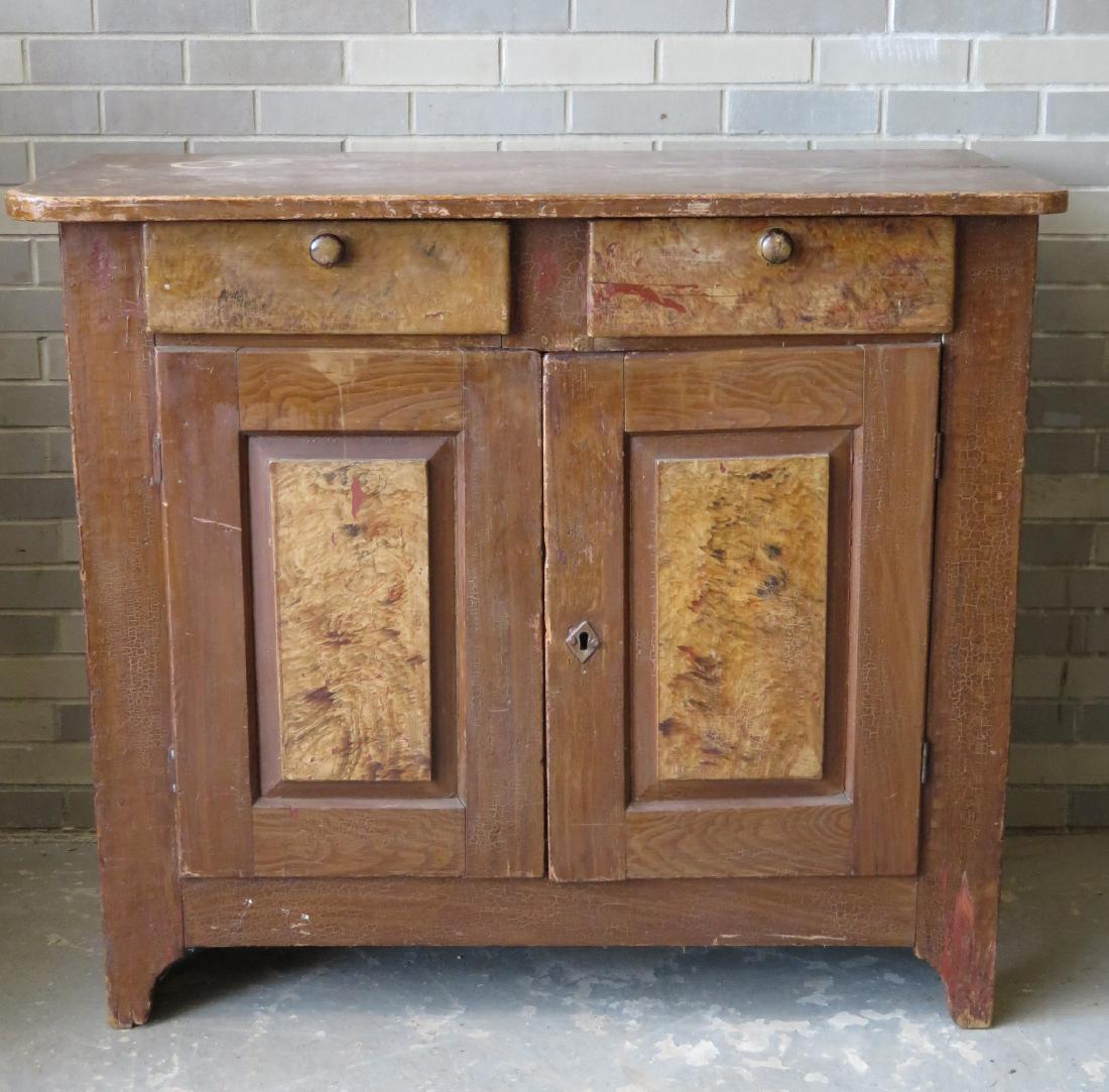 Grain painted cupboard having 2 drawers over 2 paneled: Grain painted cupboard having 2 drawers over 2 paneled doors - old brown/yellow grain paint over original red paint. Early to mid 19th century. Very good condition. 45.5"W x 21.75"D x 40"H.