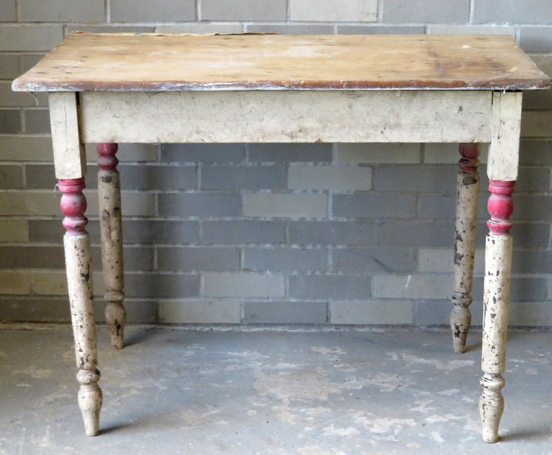 Small primitive kitchen work table with turned legs in: Small primitive kitchen work table with turned legs in old paint, center drawer, and scrubbed top. Early 19th to 20th century. 40"L x 26"w x 29.5"H. Good condition. Provenance: Found in the old Sleigh