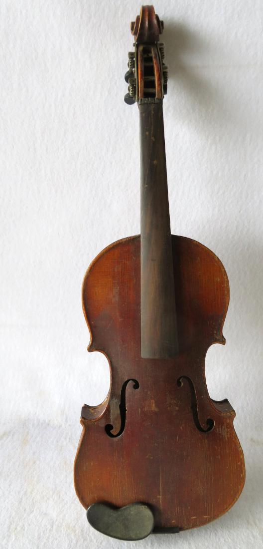 Violin in original case - no bow. Interior with paper: Violin in original case - no bow. Interior with paper label that reads "Dominecus Montagnana / Sub Signo Cremonae Venetia 17xx / Made in Germany". Surface scratches, slight separation of neck from bod