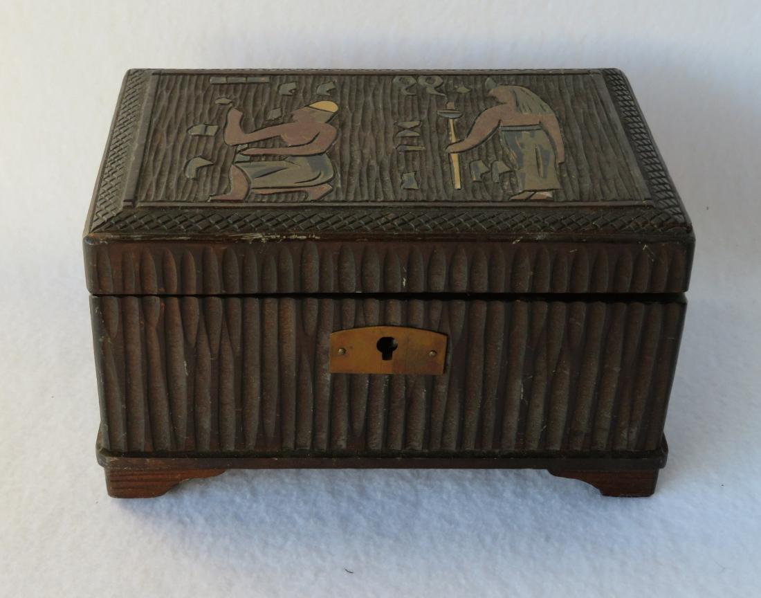 Small Art Deco ladies trinket/music box. The lid with: Small Art Deco ladies trinket/music box. The lid with carved Egyptian motif, and the interior with mirror - very good condition, circa 1920-40 - 6.25"W x 3.5"H.