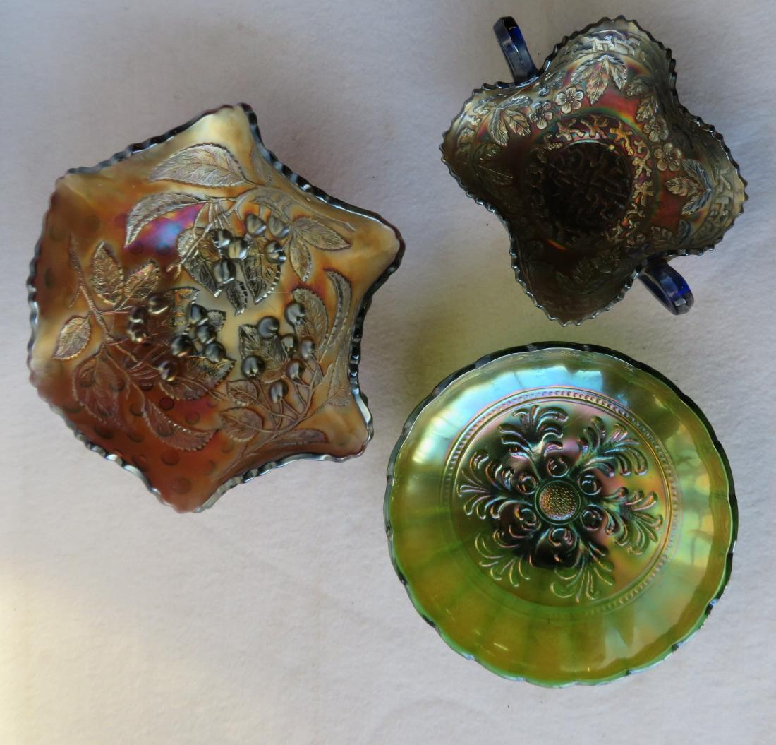 Three pieces of vintage Carnival glass including one in: Three pieces of vintage Carnival glass including one in greenish gold color - 8.25"D, another with blue handles and iridescent peach color in a stylized leaf form decorated with flowers and leaves - 7