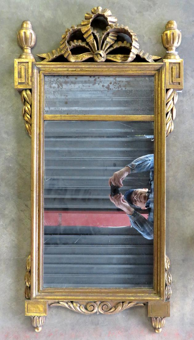 Don Ruseau (attributed) ornate French style wall: Don Ruseau (attributed) ornate French style wall mirror, carved wood frame having urn finials and scrolls at the base and various acanthus decorations on sides. Original gold paint, not signed - very 