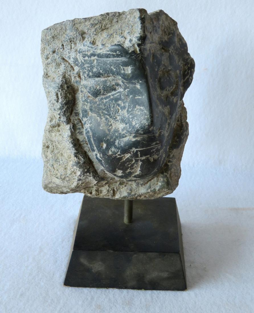 Carved stone sculpture of a stylized man - 19th century: Carved stone sculpture of a stylized man - 19th century or earlier - the sculpture itself approximately 10"H x 7"W, mounted on museum stand. Very good condition.
