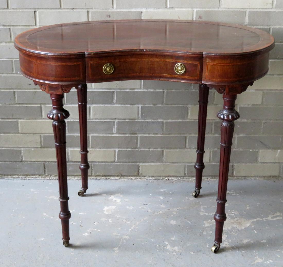 French kidney shaped rosewood and mahogany lady's desk.: French kidney shaped rosewood and mahogany lady's desk. The top with double banded inlay, and the serpentine center drawer with original brass pulls and banded inlay - fluted legs with original brass 