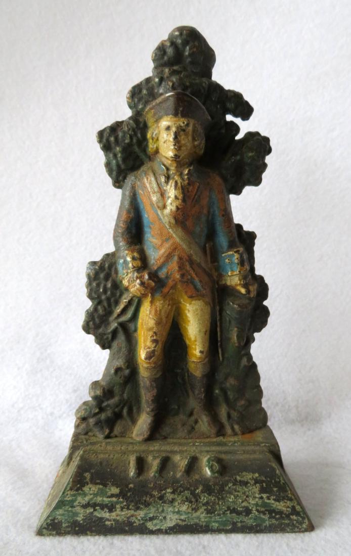 Cast iron door stop of a Minuteman, marked "1776 "on (1 of 6)