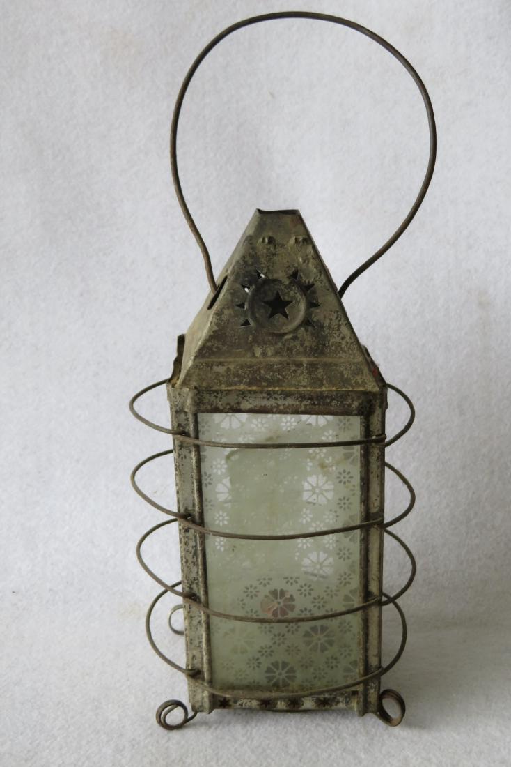 An early tin candle lantern with bale handle and having (1 of 3)