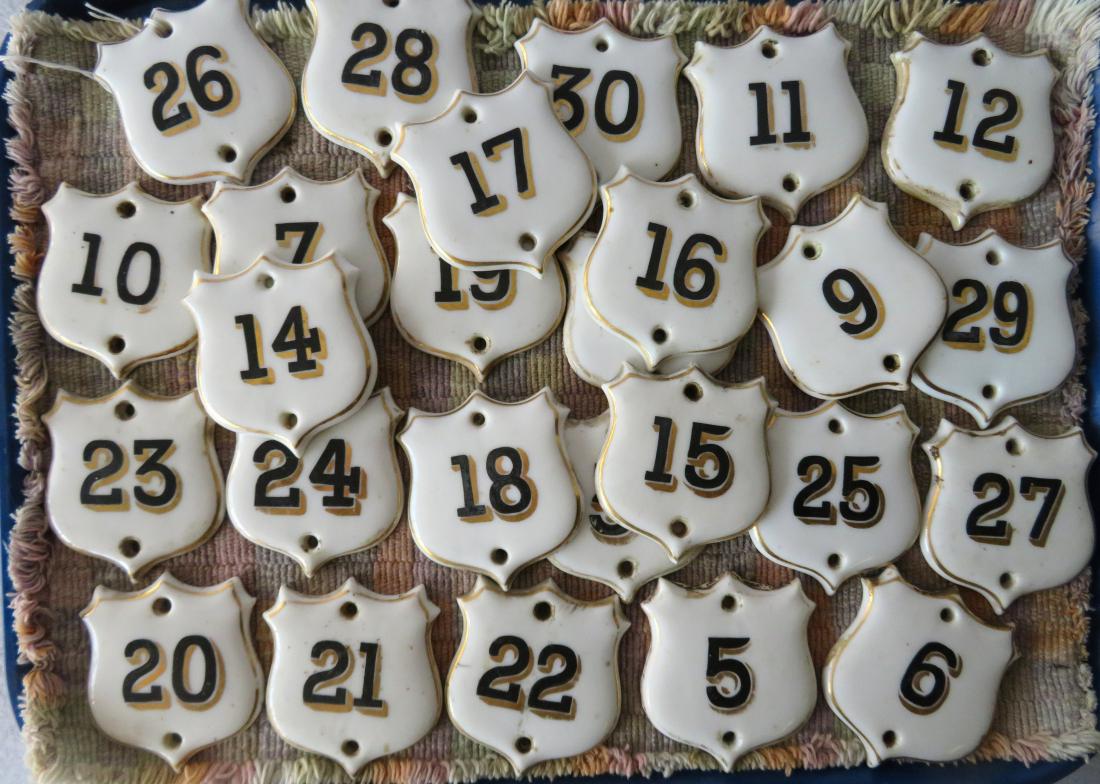 Grouping of 26 hand painted shield-shaped porcelain (1 of 3)