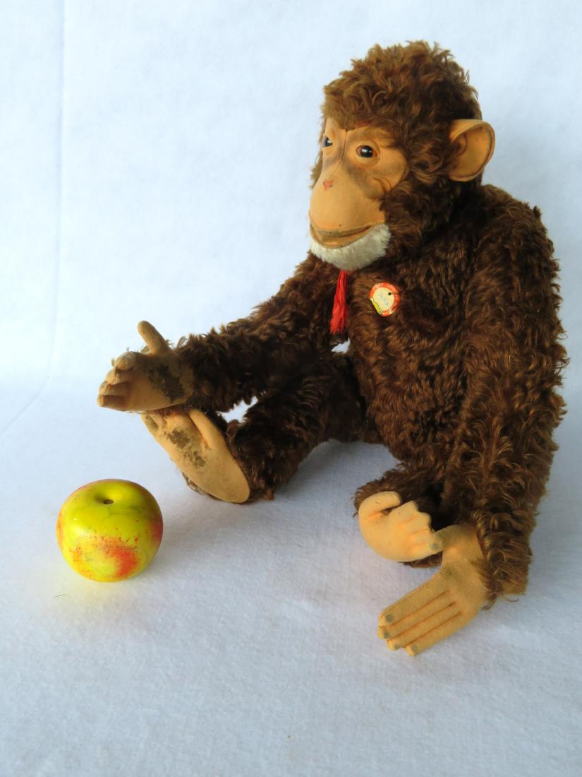 Large Steiff Jocko the monkey, with original paper tag: Large Steiff Jocko the monkey, with original paper tag attached to chest and missing button in ear, circa 1952-53. 24.5"H. Staining to bottom of right hand and to bottom of feet, no wear to mohair, ov