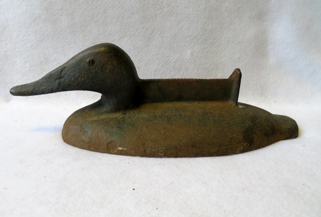 Early cast iron duck form boot scraper with incised