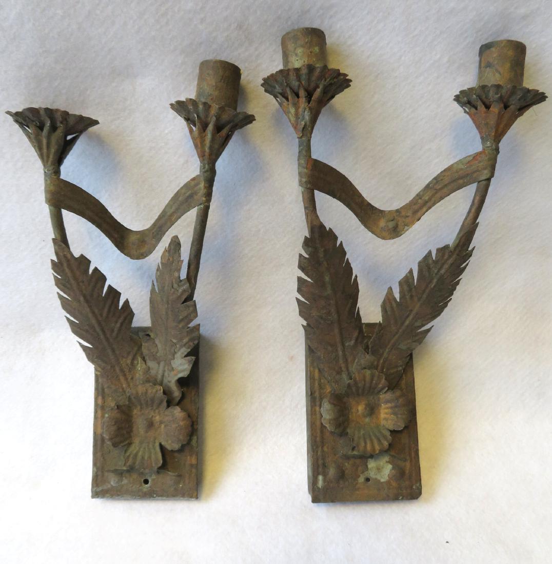 Pair of tin candle wall sconces each in the form of a: Pair of tin candle wall sconces each in the form of a double flower with hand cut leaves covering the front stems, and traces of original gilding - please note tubular construction of floral stems lea